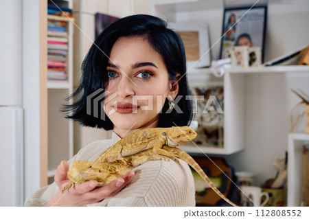 Beautiful Woman Posing with Her Two Adorable Bearded Dragon Pets Beautiful Woman Posing with Her Two Adorable Bearded Dragon Pets 112808552
