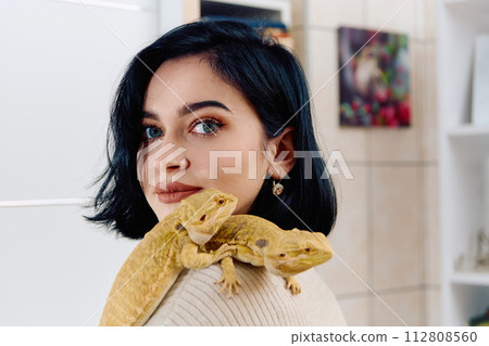 Beautiful Woman Posing with Her Two Adorable Bearded Dragon Pets Beautiful Woman Posing with Her Two Adorable Bearded Dragon Pets 112808560