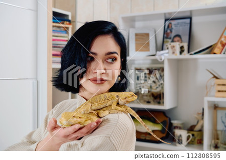 Beautiful Woman Posing with Her Two Adorable Bearded Dragon Pets 112808595