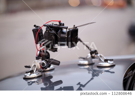 A professional camera rig is mounted on a vehicle, ready for filming cinematic projects and advertisements on the go 112808646