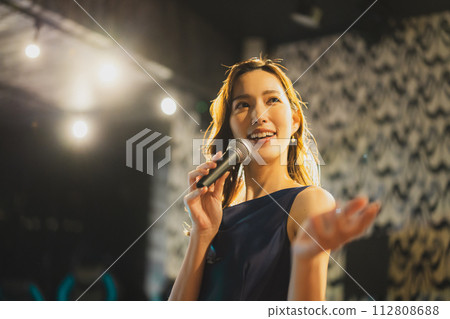 A woman singing a song passionately 112808688
