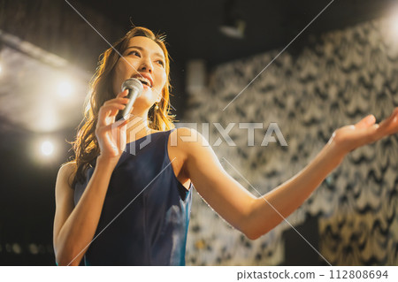 A woman singing a song passionately A woman singing a song passionately 112808694