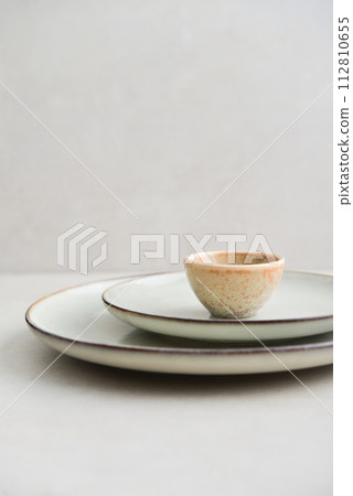 Two plates of different sizes and tiny bowl 112810655