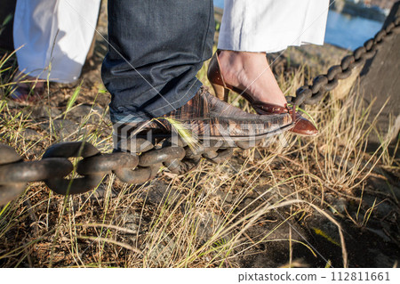 Steps Together A Couples Feet Clad in Formal Shoes on Rustic Ground 112811661