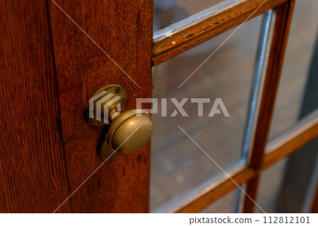 Retro wooden door and brass doorknob Retro wooden door and brass doorknob 112812101