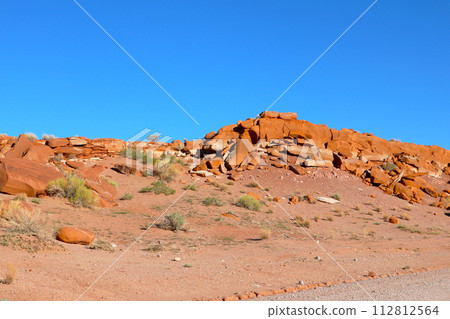 Massive Rock Formation in Desert Landscape Massive Rock Formation in Desert Landscape 112812564