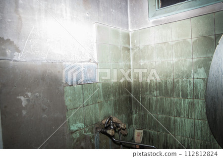Consequences after a short circuit, burnt house interior, damaged apartment after fire, burned room, charred furniture, household items  and things, garbage 112812824