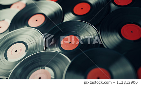 Vintage vinyl records, carefully arranged in a spiral pattern, evoke a sense of nostalgia 112812900