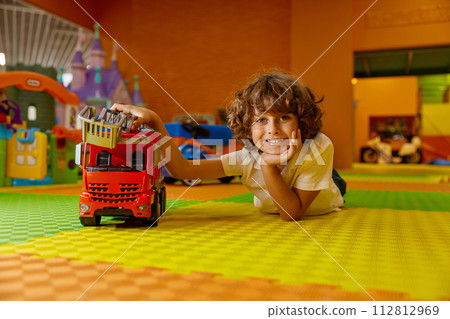 Boy child playing vehicle toys at kids care center 112812969