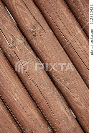 The texture of the logs. Wall of a rural house made of wooden logs with knots. Wooden background, copy space. 112813428