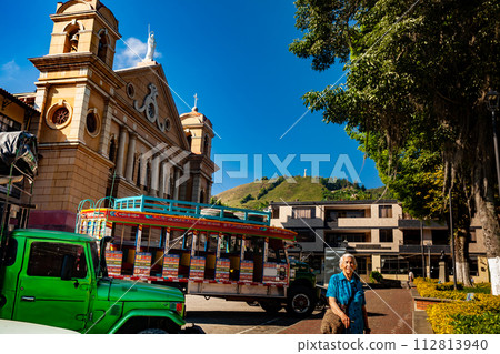 Senior woman tourist at the central square of the beautiful small town of Pacora in the department of Caldas in Colombia Senior woman tourist at the central square of the beautiful small town of Pacora in the department of Caldas in Colombia 112813940
