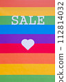Rainbow flag with the word SALE and a white heart. 112814032