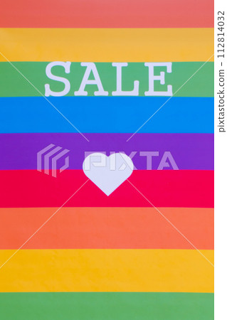 Rainbow flag with the word SALE and a white heart. 112814032