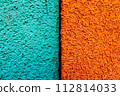 Texture of cyan and orange background, half two colors, macro. Black line in between. 112814033