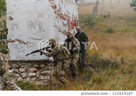 In a high stakes mission, a specialized military unit executes a tactical operation to secure a dangerous house where terrorists are believed to be hiding, showcasing precision and coordinated 112814187