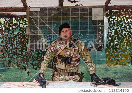 The esteemed leader of an elite military unit, strategic brilliance unfolds as he meticulously devises tactical plans for the upcoming military operation, surrounded by cutting-edge technology and a The esteemed leader of an elite military unit, strategic brilliance unfolds as he meticulously devises tactical plans for the upcoming military operation, surrounded by cutting-edge technology and a 112814190