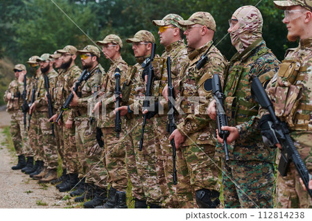 Soldier fighters standing together with guns. Group portrait of US army elite members, private military company servicemen, anti terrorist squad 112814238