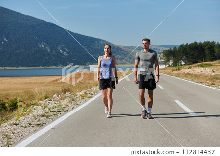 After-Run Relaxation: Romantic Couple Rests Following Intense Training Session. After-Run Relaxation: Romantic Couple Rests Following Intense Training Session. 112814437