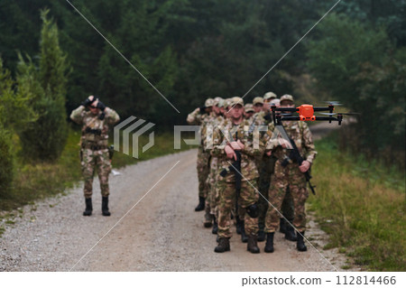 An elite military unit, led by a major, confidently parades through dense forest, showcasing precision, discipline, and readiness for high-risk operations An elite military unit, led by a major, confidently parades through dense forest, showcasing precision, discipline, and readiness for high-risk operations 112814466