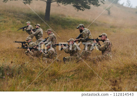 A disciplined and specialized military unit, donned in camouflage, strategically patrolling and maintaining control in a high-stakes environment, showcasing their precision, unity, and readiness for 112814543