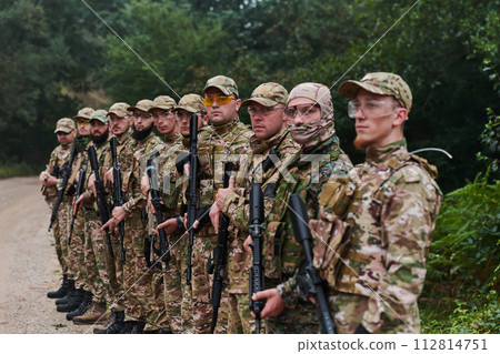 Soldier fighters standing together with guns. Group portrait of US army elite members, private military company servicemen, anti terrorist squad 112814751