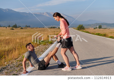 Morning Stretch: Romantic Couple Prepares for Early Morning Run 112814913