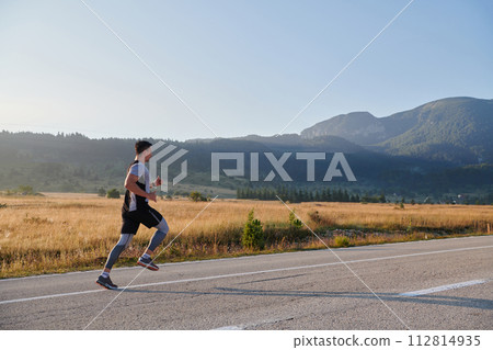 Determined Stride: Athletic Man Embarks on Marathon Preparation with Resolve. 112814935