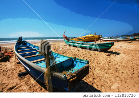 Awe view Fishing boats on beach ( there also many tourists) in fisshing village in Goa or Kerala ot Karnataka. People walking in distance Awe view Fishing boats on beach ( there also many tourists) in fisshing village in Goa or Kerala ot Karnataka. People walking in distance 112816726