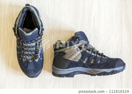 Pair of modern fashionable shoes on wooden background. Top view. Pair of modern fashionable shoes on wooden background. Top view. 112818329