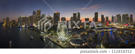 Miami marina harbor and skyscrapers of Brickell, city financial center. Skyviews Miami Observation Wheel at Bayside Marketplace with reflections in Biscayne Bay water and US urban landscape at night 112818352