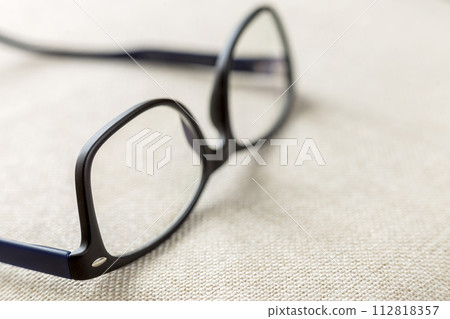 Reading spectacles, fashionable eyeglasses isolated on blurred white copy space background. 112818357