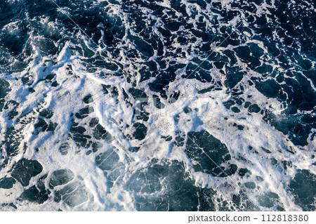 Top down aerial view of sea water surface. White foam waves texture as natural background. 112818380