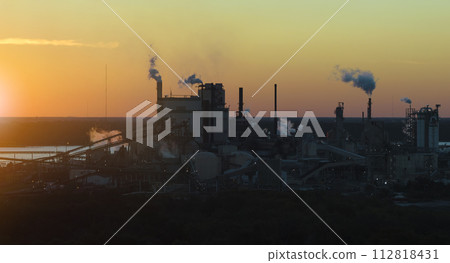 Aerial view of large factory with smokestack from production pro Aerial view of large factory with smokestack from production pro 112818431