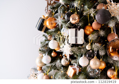 Christmas tree close up standing white wall Christmas tree close up standing white wall 112819419