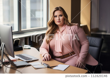 Office worker, beautiful woman at workplace. Plus-size manager Office worker, beautiful woman at workplace. Plus-size manager 112820146
