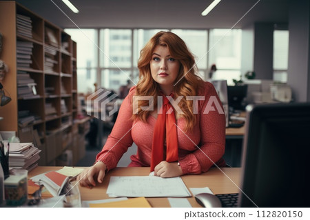 Office worker, beautiful woman at workplace. Plus-size manager 112820150