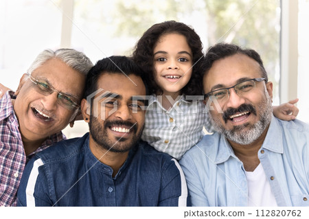 Cheerful Indian girl, father, granddad, great grandfather looking at camera 112820762