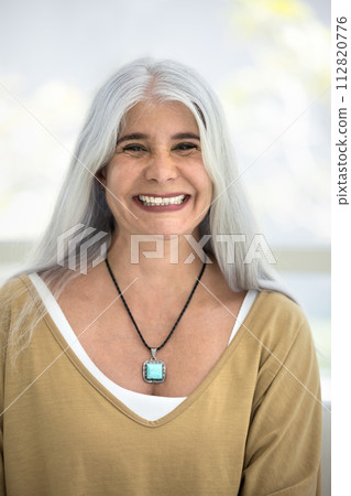 Cheerful positive older Latin pensioner woman looking at camera Cheerful positive older Latin pensioner woman looking at camera 112820776