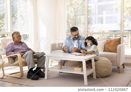Happy Indian grandpa and granddaughter girl drawing in paper album Happy Indian grandpa and granddaughter girl drawing in paper album 112820867