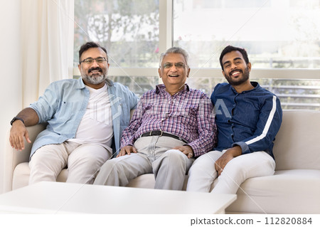 Adult Indian grandson and son spending leisure time with grandpa Adult Indian grandson and son spending leisure time with grandpa 112820884