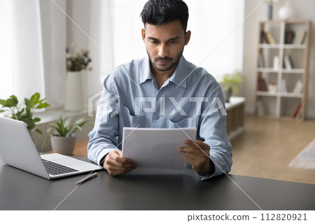 Serious Indian business man working with papers 112820921