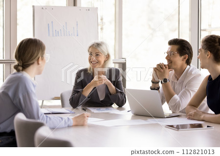 Staff take part in morning briefing in modern conference room Staff take part in morning briefing in modern conference room 112821013