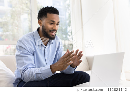 Positive young African business man talking on work video call 112821142