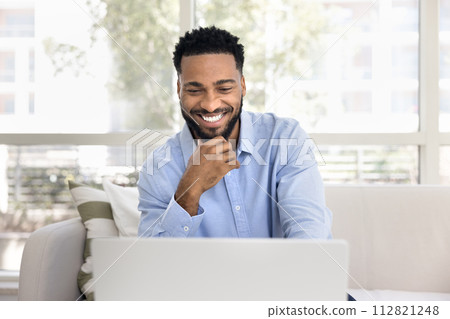 Happy successful African freelancer man working from home Happy successful African freelancer man working from home 112821248