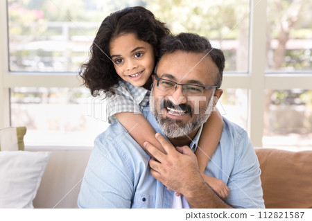 Cheerful cute Indian preschool kid girl hugging happy loving grandpa 112821587