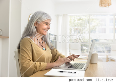Cheerful elderly Hispanic freelance business woman enjoying remote job Cheerful elderly Hispanic freelance business woman enjoying remote job 112821596
