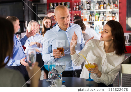 Woman rejecting man on corporate party Woman rejecting man on corporate party 112822678