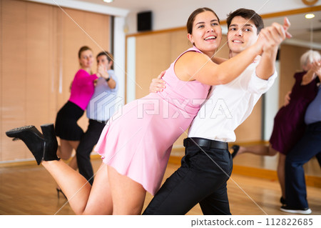 Young pair practicing ballroom dance in dance studio Young pair practicing ballroom dance in dance studio 112822685