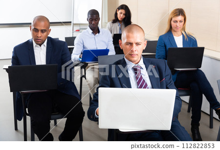 conference of international financial managers with laptop in white room 112822853