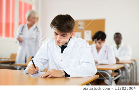 Young student listening to lecture during professional medical training Young student listening to lecture during professional medical training 112823004